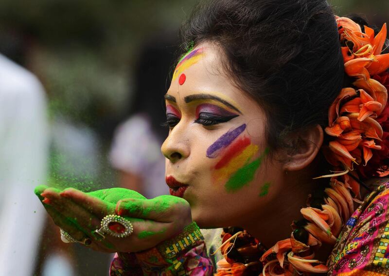 An Indian reveller plays with coloured powder during celebrations for the Holi festival in Siliguri, West Bengal.Diptendu Dutta / AFP Photo