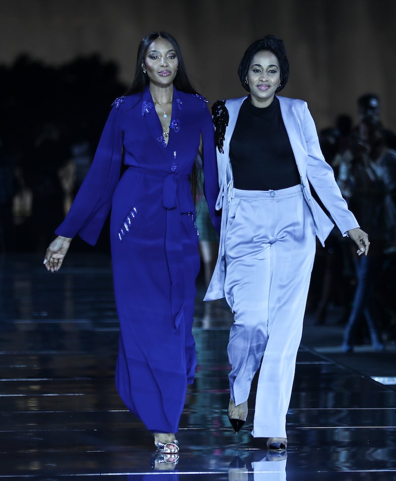 British model Naomi Campbell (L) presents a creation by Hudayya Fadoul Abacha (R), chief executive of Hudayya Couture Limited. EPA
