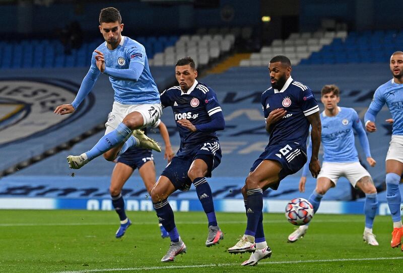 Manchester City's Spanish midfielder Ferran Torres (L) shoots wide of the post during the UEFA Champions League football Group C match between Manchester City and Olympiakos at the Etihad Stadium in Manchester, north west England on November 3, 2020. (Photo by Paul ELLIS / AFP)