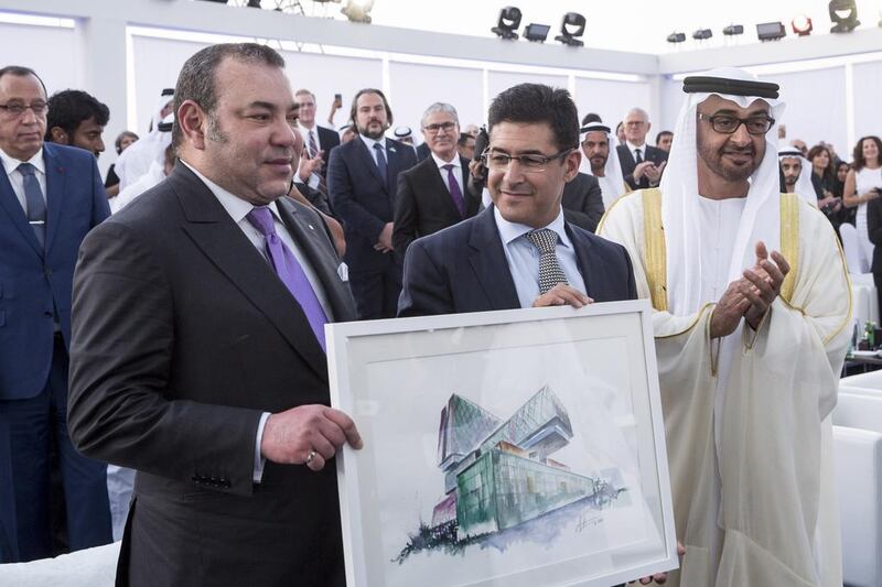 Sheikh Mohammed bin Zayed, Crown Prince of Abu Dhabi and Deputy Supreme Commander of the UAE Armed Forces, and King Mohammed VI of Morocco, left, present Dr Marc Harrison, former chief executive of Cleveland Clinic Abu Dhabi, with a painting of the new hospital during the facility’s opening ceremony. Ryan Carter / Crown Prince Court – Abu Dhabi