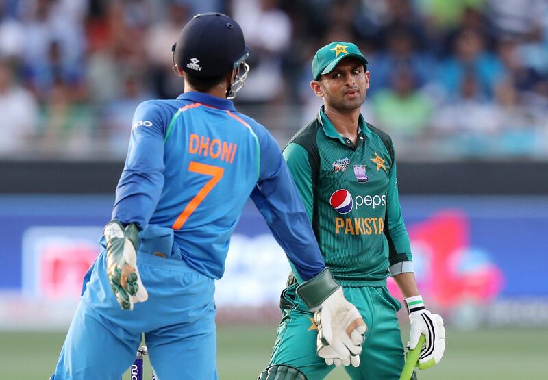 Dubai, United Arab Emirates - September 23, 2018: Pakistan's Shoaib Malik stares at India's MS Dhoni during the game between India and Pakistan in the Asia cup. Sunday, September 23rd, 2018 at Sports City, Dubai. Chris Whiteoak / The National