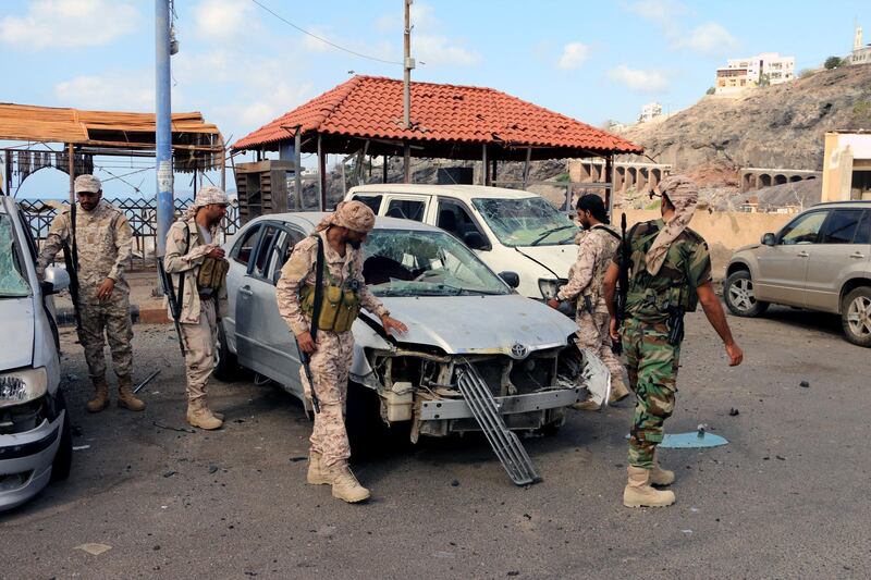 epa06563818 Yemeni soldiers inspect the site of car bomb attacks outside the headquarters of a counter-terrorism unit in the southern port city of Aden, Yemen, 25 February 2018. According to reports, at least 14 Yemenis were killed and 40 others wounded when two car suicide bombers struck the entrance of the headquarters of a counter-terrorism unit in Aden.  EPA/STRINGER