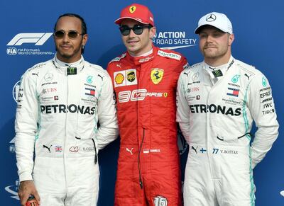 epa07825519 Monaco's Formula One driver Charles Leclerc (C) of Scuderia Ferrari celebrates taking the pole position with second placed British Formula One driver Lewis Hamilton (L) of Mercedes AMG GP and third placed Finnish Formula One driver Valtteri Bottas of Mercedes AMG at the Monza Autodrome in Monza, Italy, 07 September 2019. The Formula One Grand Prix of Italy takes place on 08 September 2019.  EPA/DANIEL DAL ZENNARO
