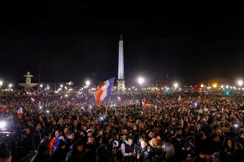 Fans wait at the Place de la Concorde in Paris for the arrival of the French football team. AFP