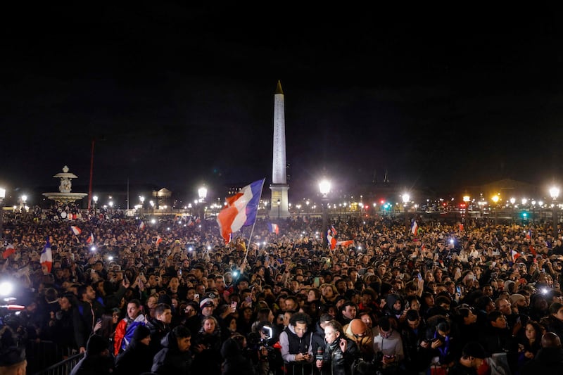 Fans wait at the Place de la Concorde in Paris for the arrival of the French football team. AFP