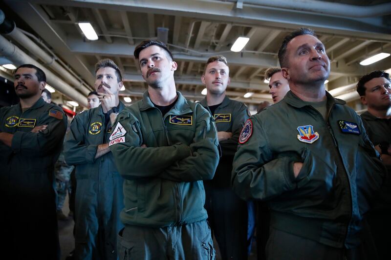 HSC-23 Navy flight crew members watch as the Orion capsule floats in the well deck after being successfully secured off the coast of Baja California, Mexico. EPA