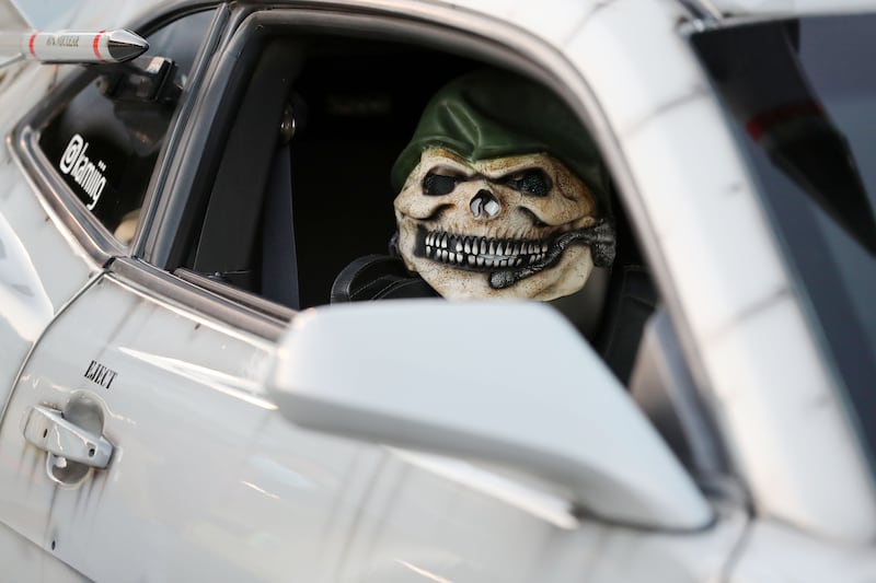 Drivers showed off their cars wearing costume masks. There were about 50 cars participating.
