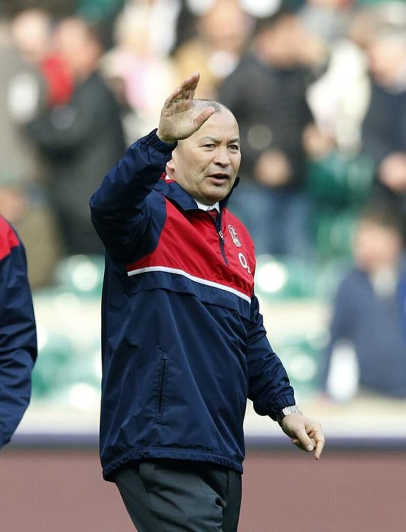 England coach Eddie Jones waves as he watches the warmup before the Six Nations international rugby match between England and Wales at Twickenham stadium in London, Saturday, March,12, 2016. (AP Photo/Alastair Grant)