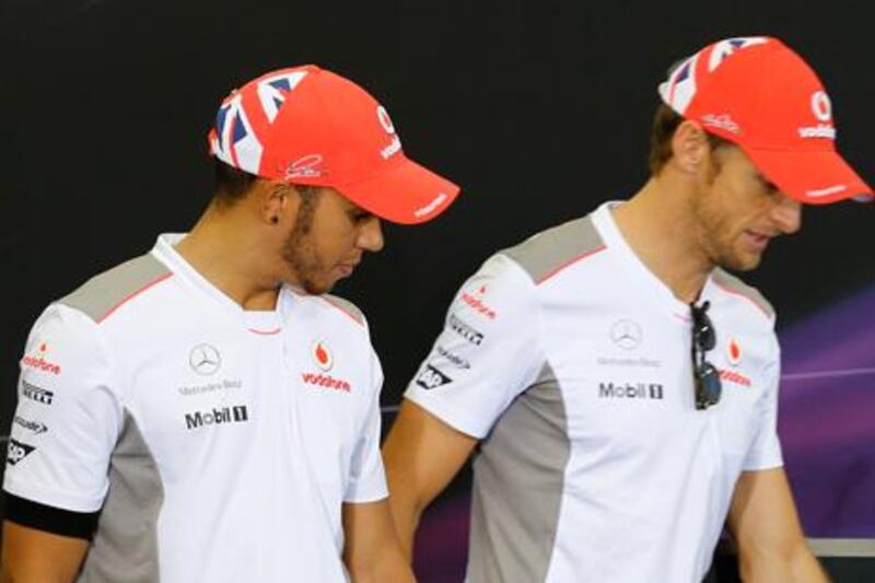 McLaren teammates Lewis Hamilton and Jenson Button at a news conference before the Japanese Grand Prix