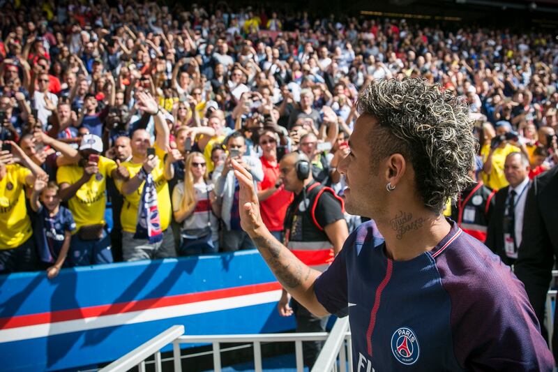 Brazilian soccer star Neymar waves to fans, at the Parc des Princes stadium in Paris, Saturday, Aug. 5, 2017, during his official presentation ahead of Paris Saint-Germain's season opening match against Amiens. Paris Saint-Germain fans got their first chance to see Neymar inside the Parc des Princes but the world's most expensive player left the pitch after 24 minutes. Neymar cannot play as the club did not receive his international transfer certificate before Friday night's deadline despite his 222 million-euro ($262 million) move from Barcelona being completed the previous day. (AP Photo/Kamil Zihnioglu)