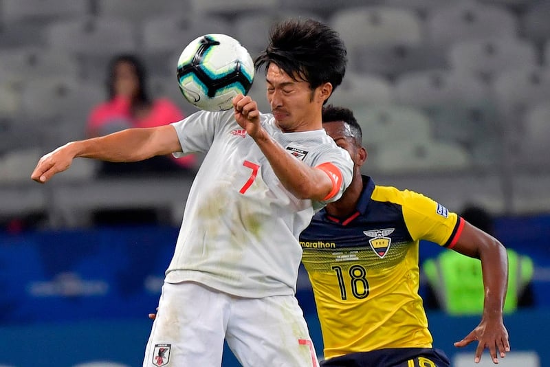 Japan's Gaku Shibasaki heads the ball. AFP