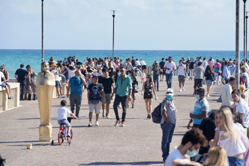 People take a walk along the pier in Ostia, near Rome. AP