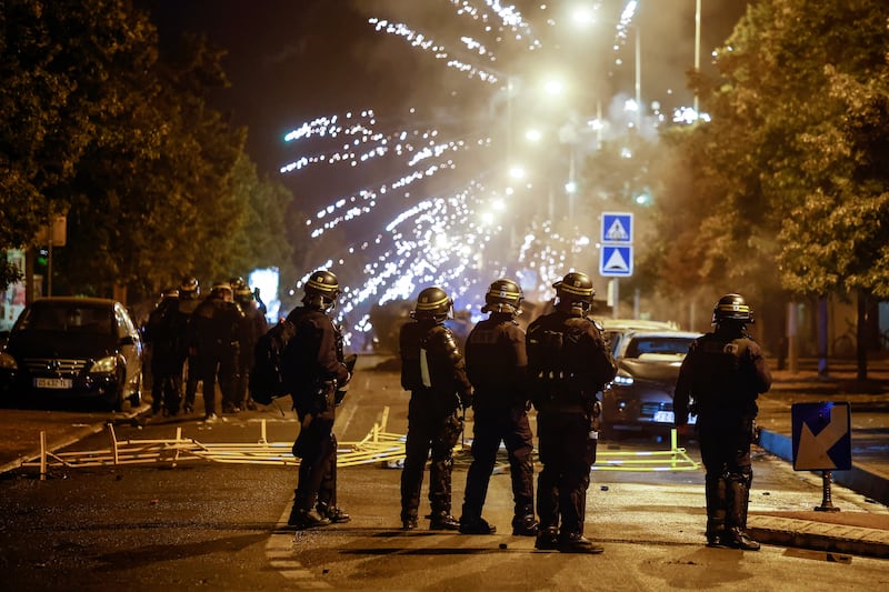 Protesters hurl fireworks at Paris riot officers. EPA