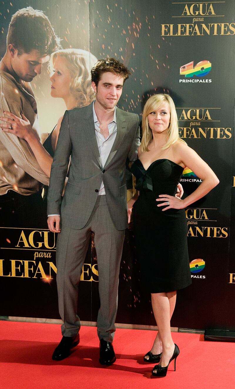 Wearing a grey suit, Robert Pattinson poses with Reese Witherspoon at the Spanish premiere for 'Water for Elephants' in Barcelona on May 1, 2011. Getty Images