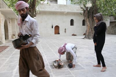 Yazidi woman Ashwaq Haji (R), allegedly used by the Islamic State group (IS) as a sex slave, visits the Lalish temple in tribute to the jihadists' victims from her village of Kocho near Sinjar, in Lalish, northern Iraq, on August 15, 2018. - A young Yazidi woman who fled to Germany but returned home to northern Iraq says she cannot escape her Islamic State group captor who held her as a sex slave for three months. 
Ashwaq Haji, 19, says she ran into the man in a German supermarket in February. Traumatised by the encounter, she returned to Iraq the next month. Like many other Yazidis, she was kidnapped by IS when the jihadists seized swathes of Iraq in the summer of 2014. (Photo by - / AFP)