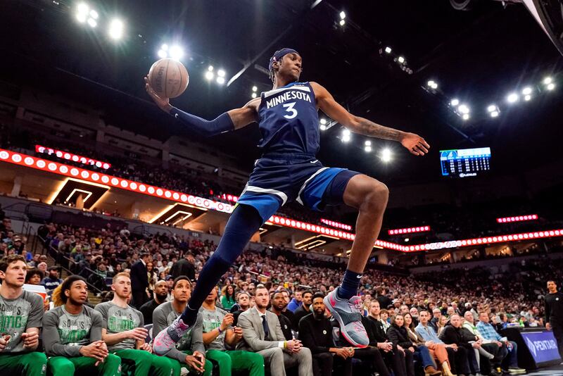 Minnesota Timberwolves forward Jaden McDaniels attempts to save a ball from going out of bounds against the Boston Celtics at Target Centre. Reuters