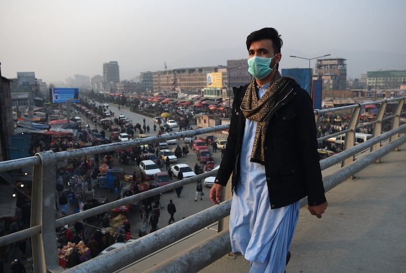 An Afghan resident walks along an overpass amid heavy smog conditions in Kabul. AFP