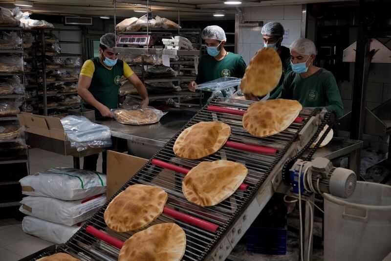 Workers at a bakery in Beirut. Lebanon is among regional countries facing high inflation. AP Photo