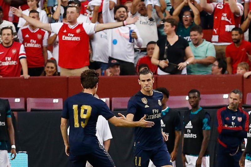 Real Madrid forward Gareth Bale celebrates with Real Madrid defender Alvaro Odriozola after scoring a goal against Arsenal. Reuters