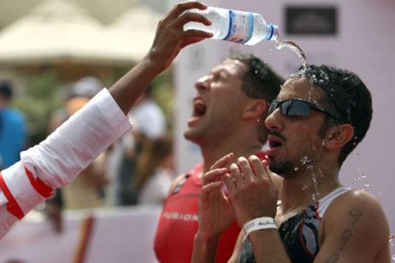 A competitor gets a little help cooling off after competing in the Abu Dhabi International Triathlon. A record number of entries, 1,855, representing 62 countries, participated.