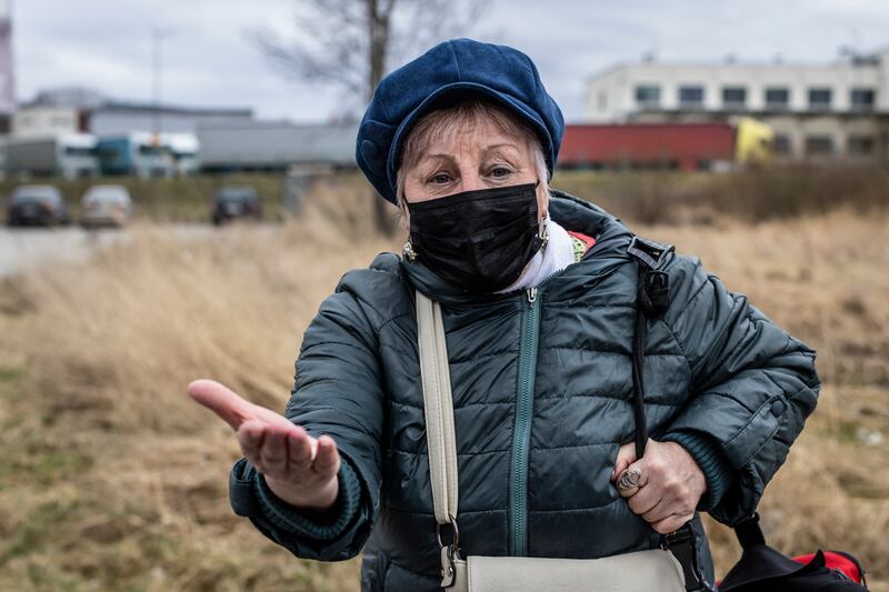 Ania, 67, a Ukrainian, gestures on the pedestrian border cross in Medyka, south-east Poland. AFP