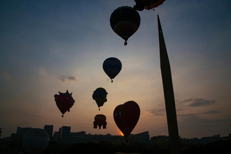 Hot air balloons fly during the 10th Putrajaya International Hot Air Balloon Fiesta in Putrajaya, Malaysia. AP Photo