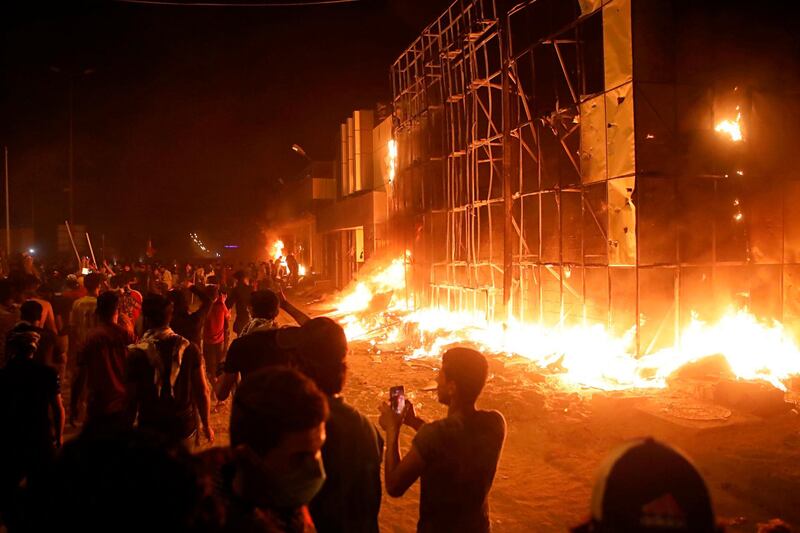 Protestors burn local parties offices. AP