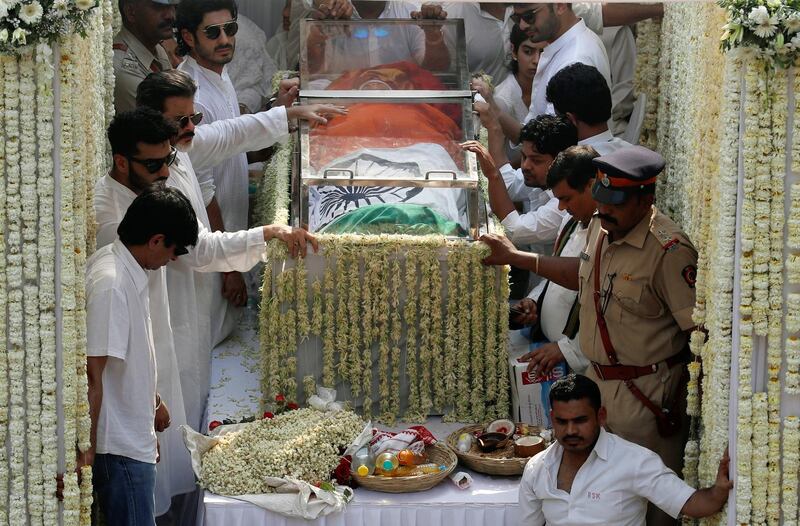 Friends and family members stand next to the body of Bollywood actress Sridevi draped in Indian national flag during her funeral procession in Mumbai, India, February 28, 2018. REUTERS/Danish Siddiqui