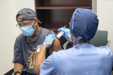 Volunteers are given shots of Moderna's Covid-19 vaccine  during a trial in Michigan. AFP