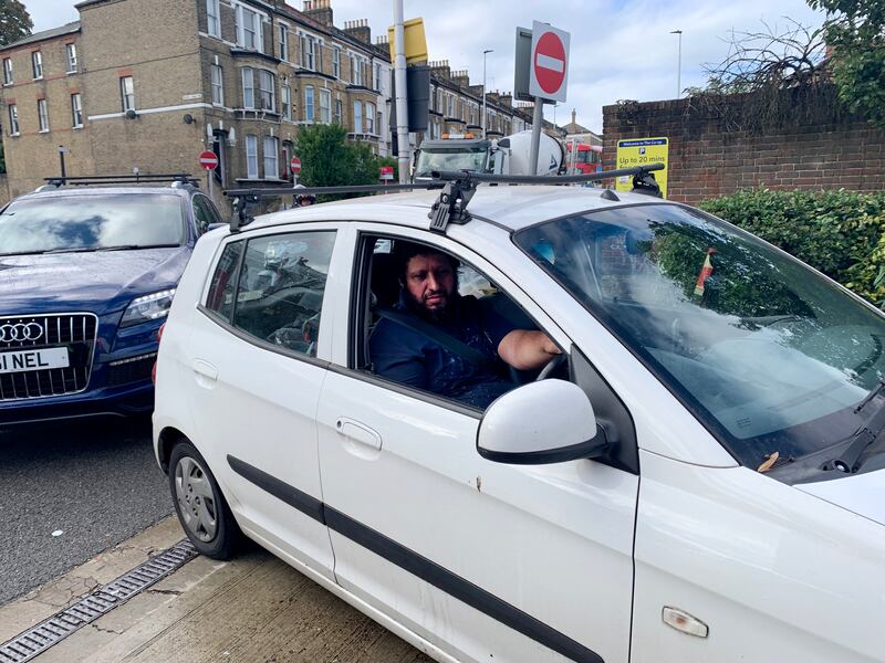 Antonio Abreu queues for petrol in south-west London. He told 'The National' he had been queueing for 20 minutes and was late for work. Laura O'Callaghan / The National