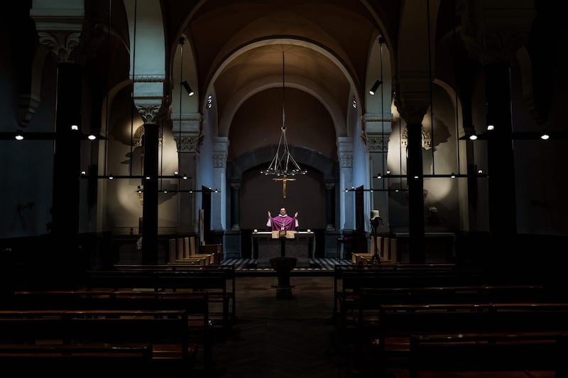 Auxiliary bishop of Lyon Emmanuel Gobilliard holds a streamed live Mass in the empty Saint-Irenee church, in Lyon on the eighth day of a lockdown aimed at curbing the spread of the virus.  AFP