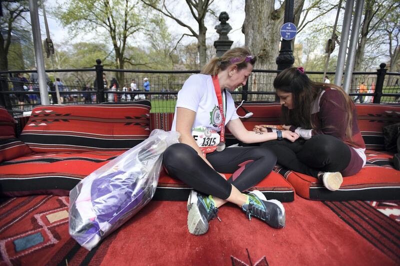 MANHATTAN, NEW YORK, APRIL 29, 2018 People are seen participating in the 2018 UAE Healthy Kidney 10K Run in Central Park in  Manhattan, NY.  Runner Rosey Marchiori gets a henna tattoo after her race. 4/29/2018 Photo by ©Jennifer S. Altman All Rights Reserved