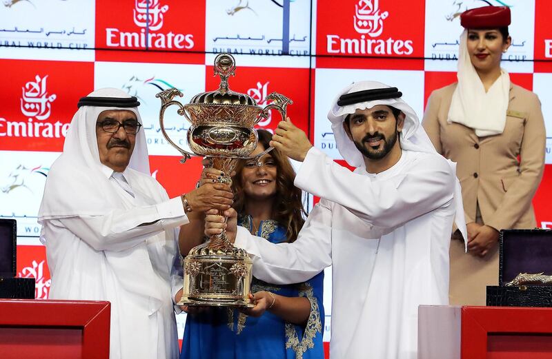 DUBAI , UNITED ARAB EMIRATES , MARCH 31  – 2018 :- Left to Right- Sheikh Hamdan Bin Rashid Al Maktoum , UAE Minister of Finance , Deputy Ruler of Dubai, Sheikha Al Jalila Bint Mohammed Bin Rashid Al Maktoum and  Sheikh Hamdan bin Mohammed bin Rashid Al Maktoum , crown prince of Dubai  with the Dubai World Cup trophy after Thunder Show (IRE) ridden by Christophe Soumillon  ( no 10  ) won the 9th horse race Dubai World Cup 2000m dirt during the Dubai World Cup held at Meydan Racecourse in Dubai. ( Pawan Singh / The National ) For News/Sports. Story by Amith