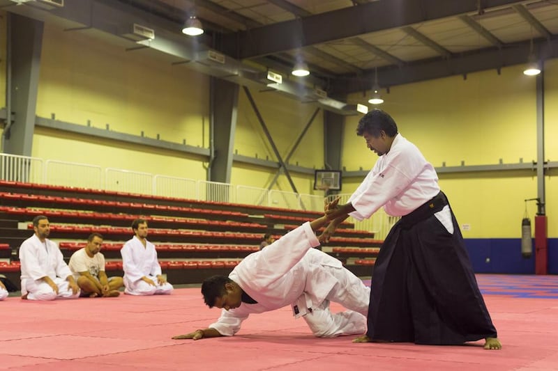 Sugumar John Ratnam, right, known to his pupils as John Sensei, shows his skills to his class at the Zanshinkan. ‘We are practising for good health, for good mind, for good spirit, good friendship and a good life. We don’t want to hurt and we don’t want to get beaten up by someone else,’ he says. Clint McLean / The National