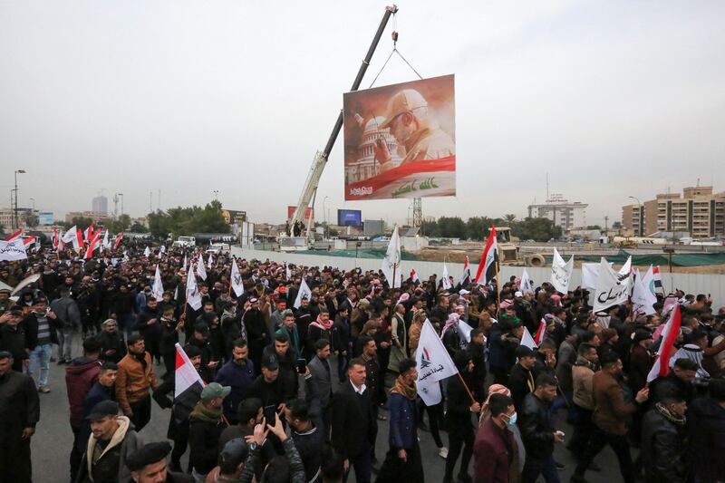 Members and supporters of the PMF, also known as Hashed Al Shaabi, take part in a demonstration and a symbolic funeral for Suleimani and Al Muhandis. AFP