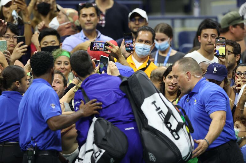 Novak Djokovic of Serbia takes selfies with fans after defeating Matteo Berrettini of Italy. AFP