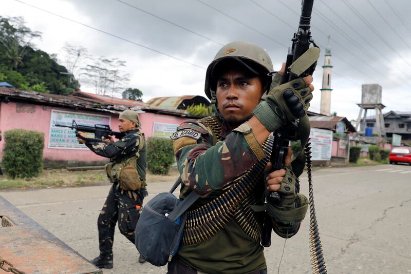 Government soldiers take cover behind a military truck, as they take up positions in Marawi City,  Philippines May 28, 2017. REUTERS/Erik De Castro