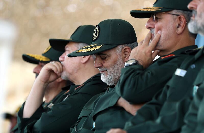 In this June 30, 2018 photo, released by an official website of the office of the Iranian supreme leader, Gen. Qassem Soleimani, center, who heads the elite Quds Force of Iran's Revolutionary Guard attends a graduation ceremony of a group of the guard's officers in Tehran, Iran. Soleimani said Thursday his forces are ready if President Donald Trump follows through on his warning that Iran will "suffer consequences" if Tehran threatens the United States. (Office of the Iranian Supreme Leader via AP)