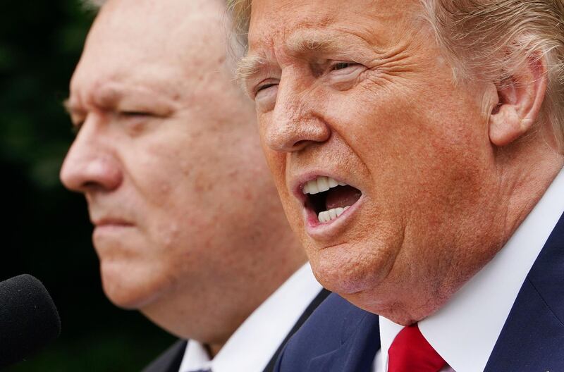 (FILES) In this file photo taken on May 29, 2020, US President Donald Trump, with Secretary of State Mike Pompeo, holds a press conference in the Rose Garden of the White House in Washington, DC. Trump on December 19, 2020, downplayed a massive cyberattack on US government agencies, declaring it "under control" and undercutting the assessment by his own administration that Russia was to blame. Trump's response came a day after Pompeo said in an interview that the attack -- which cyber experts say could have far-reaching impact and take months to unravel -- was "pretty clearly" Russia's work. / AFP / MANDEL NGAN
