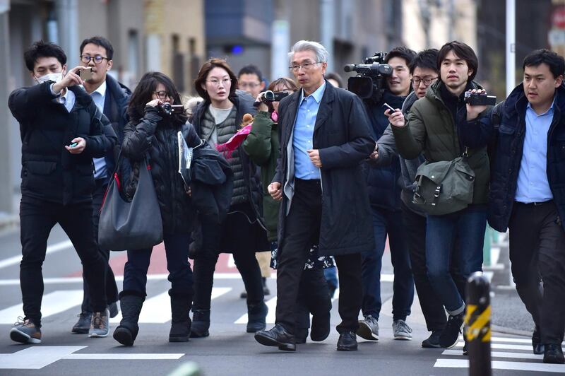 Members of the media surround Junichiro Hironaka the Japanese lawyer for former auto tycoon Carlos Ghosn as he walks to his office in Tokyo.  AFP
