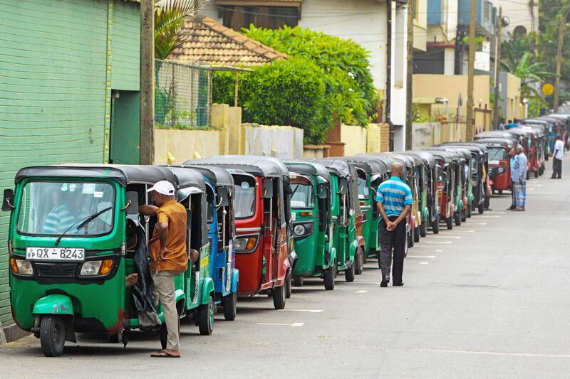 Auto rickshaw drivers queue to buy fuel in Colombo on July 3. AFP Photo