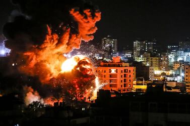 TOPSHOT - Fire and smoke billow above buildings in Gaza City during reported Israeli strikes on March 25, 2019. Israel's military launched strikes on Hamas targets in the Gaza Strip today, the army and witnesses said, hours after a rocket from the Palestinian enclave hit a house and wounded seven Israelis. / AFP / Mahmud Hams