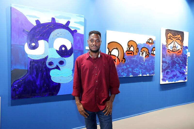 Isshaq Ismail with his Serenity painting, left