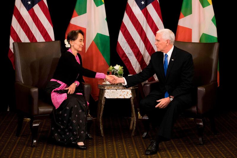 TOPSHOT - US Vice President Mike Pence (R) shakes hands with Myanmar State Counsellor Aung San Suu Kyi during a bilateral meeting on the sidelines of the 33rd Association of Southeast Asian Nations (ASEAN) summit in Singapore on November 14, 2018. / AFP / POOL / Bernat Armangue
