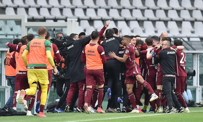 Torino players celebrate after making the score 2-1. EPA