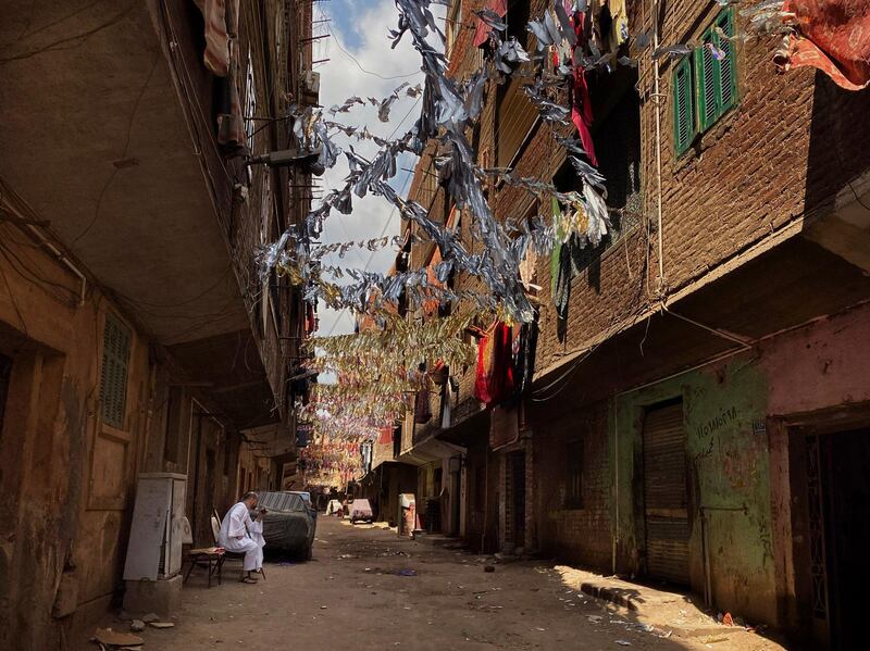 Ramadan decorations hang on a street that is on complete lockdown after a family was tested positive due to coronavirus in Bahtim, Shubra El Kheima neighbourhood of Qalyoubiya governorate. AP