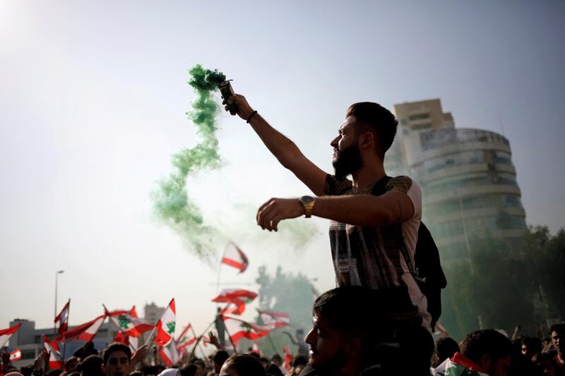 A demonstrator holds a flare during ongoing anti-government protests near the Ministry of Education and Higher Education in Beirut, Lebanon November 7, 2019. REUTERS/Andres Martinez Casares     TPX IMAGES OF THE DAY