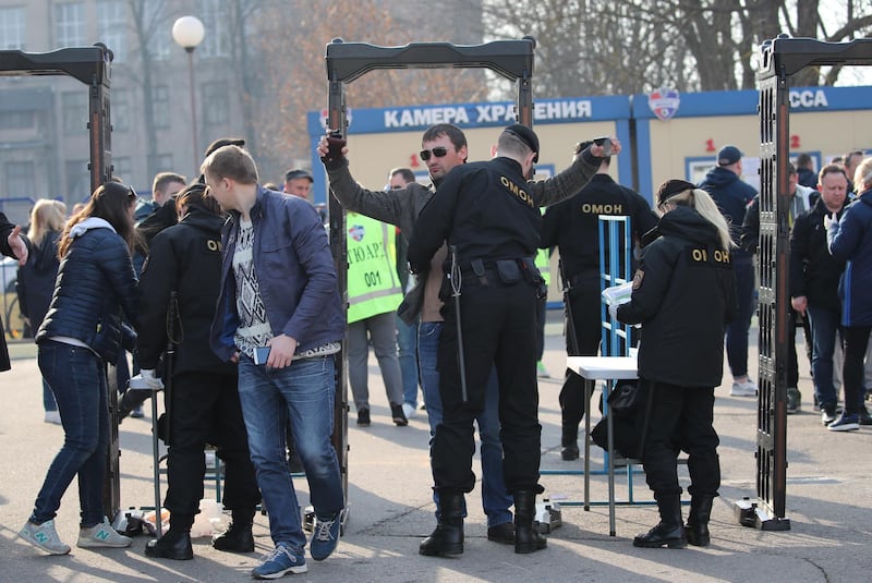 Fans are checked by security at the entrance to the stadium. EPA