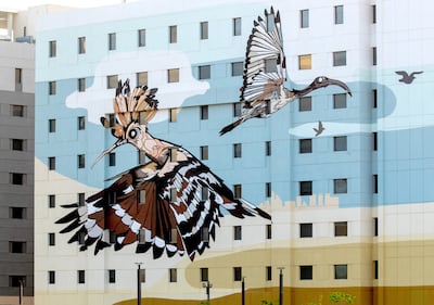 The hoopoe, left, and the African sacred ibis are among the birds depicted in Fatspatrol's large-scale mural on Yas Island. Victor Besa / The National