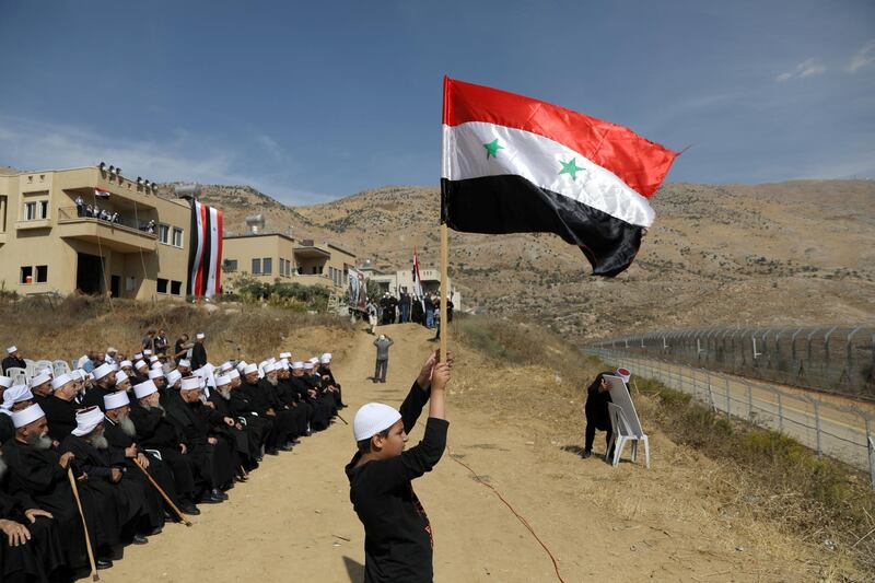 Druze people take part in a rally in Majdal Shams near the ceasefire line between Israel and Syria in the Israeli occupied Golan Heights, overlooking the other side of the border. Reuters